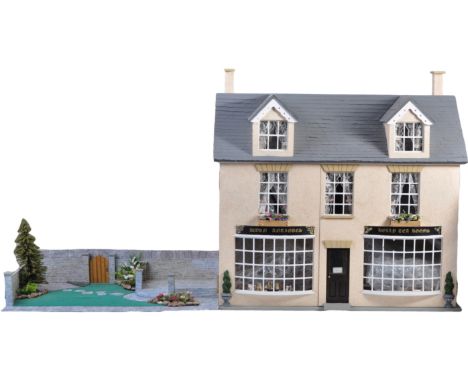 Dolls House - a large 20th century Victorian style three storey doll's house ' Acorn Antiques ' and ' Holly Tea Rooms '. Divi