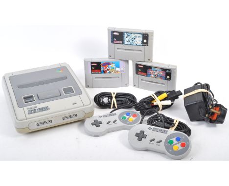 An original vintage SNES Super Nintendo Entertainment System games console and three games - Mario Paint, World Cup Striker, 