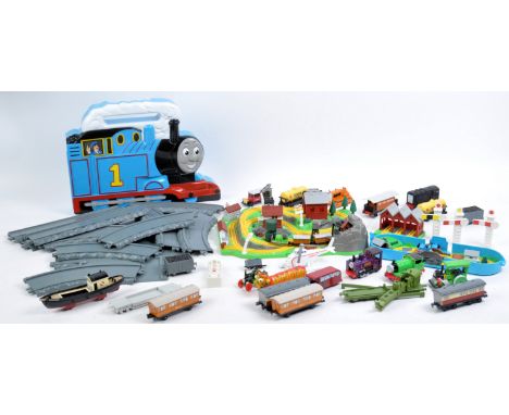 A large collection of Ertl made Thomas The Tank Engine And Friends diecast model railway trains and playset accessories to in