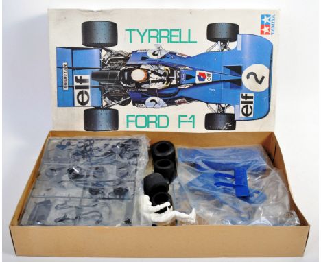 An original Tamiya made 1/12 scale Tyrrell Ford F-1 racing car plastic model kit. The kit appearing to contain correct items 