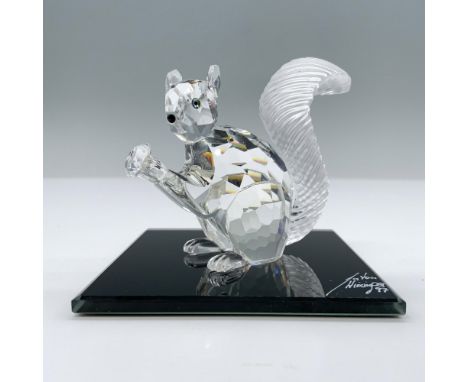 Adorable, limited edition crystal figure with frosted crystal bushy tail holding his crystal chaton, looking out with jet cry