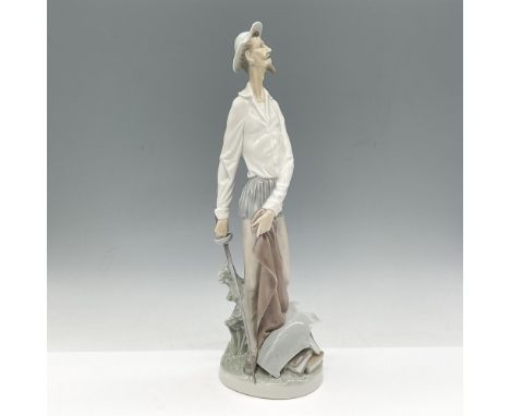 This literary standing hero is holding his sword in hand and holding cloak in other with books at his feet. Lladro backstamp.