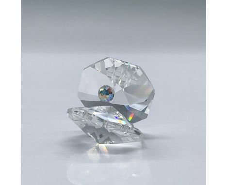This is an ethereal small faceted crystal oyster with an iridescent crystal pearl. This item has its original box measuring 3