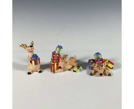 Three glossy figures depicting reindeers in different poses holding up wrapped presents. Fitz and Floyd backstamp. Largest fi
