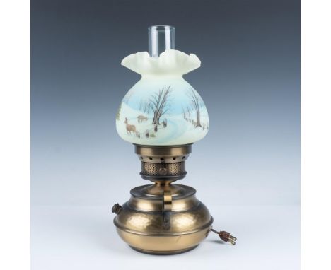 A bronze colored lamp with two elegant glass shades, one a long hurricane shade with a frosted white body and clear rim and t