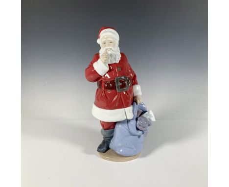 A festive glossy figure of Saint Nicholas, in his traditional red outfit and holding a bag full of gifts. Lladro backstamp. T