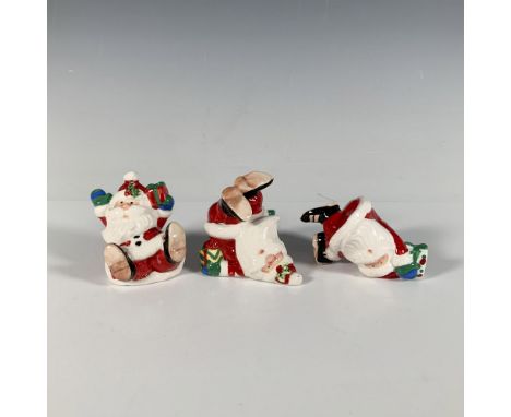 A set of three glossy Santa Claus figures, each in a different fun and jolly pose. Fitz and Floyd backstamp. This item has it