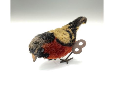 This charming little mohair bird by Schuco is a delightful collectible. Crafted with yellow, black, and rust-colored mohair, 