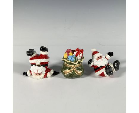 This three piece set of glossy figures depicts Santa Claus in cheerful, playful poses, with a bag of gifts. Fitz and Floyd ba