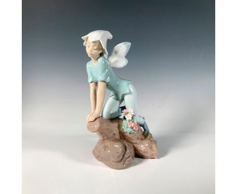 A glossy figure of a fairy kneeling on a flower-adorned branch. The first Annual Edition of the Lladro Privilege Collection i
