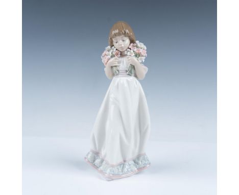 Glossy Collectors Society porcelain figure of a girl in a white dress grasping two bouquets of pink and white flowers. Lladro