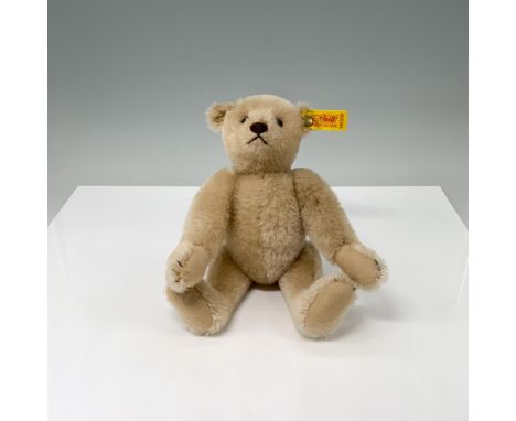 Cream color mohair bear with stitched nose and mouth, disk jointed neck, shoulders and hips, felt paw pads. Signature Steiff 