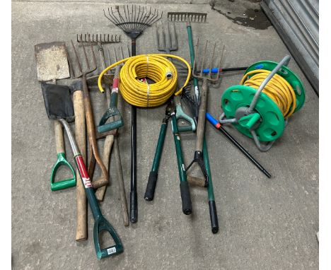 Selection of garden tools includes hose pipes, spades etc