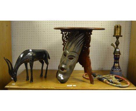 Tribal Art - a carved hardwood mask; a spelter model of a Reedbuck; an Indian carved occasional table ; a Hooka pipe (4)