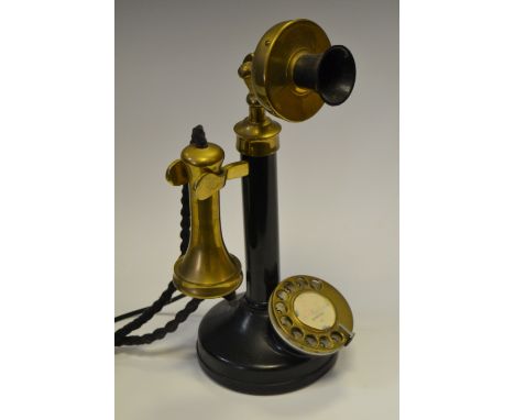 A brass and black lacquer stick telephone 