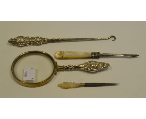 A Victorian silver hafted button hook; a similar magnifying glass; etc (4) 