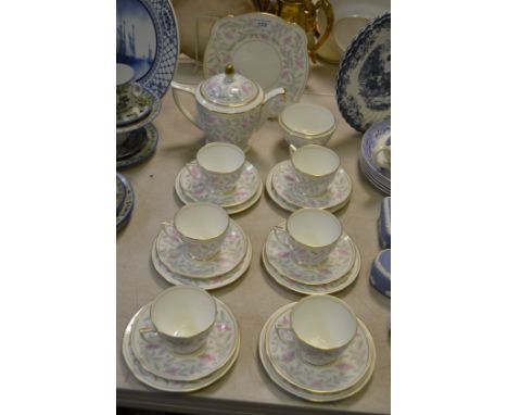 A Mintons Petunia pattern tea service, for six, comprising teapot, milk jugs, sugar bowl, teacups, saucers and side plates,  