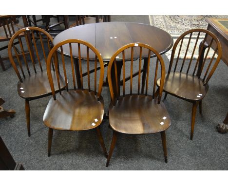 An Ercol (Blue Label) oval drop leaf dining table; a set of four conforming dining chairs (5)