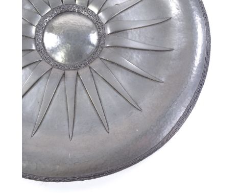 Rene Delavan, large mid-20th century pewter charger, hand beaten with applied sun ray motif, cast edging, signed to centre pa