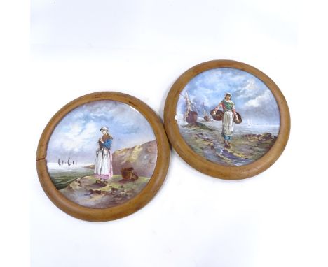 A pair of large 19th century French ceramic wall plates, with hand painted designs of fisher girls, signed A Delus, mounted i