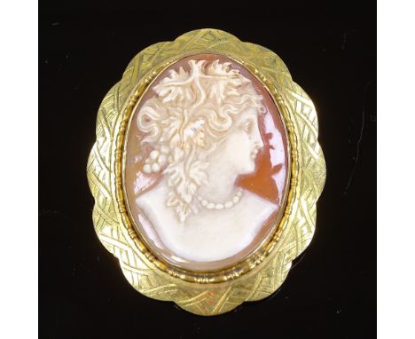 A relief carved cameo shell panel brooch, depicting female profile, in engraved rolled gold frame, brooch height 54.5mm, 15.6