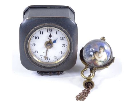 A German gun metal-cased travelling timepiece, with carrying handle and enamel dial, height 5cm, and a reproduction glass bal