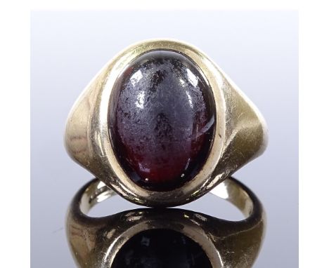 A 9ct gold cabochon garnet signet ring, hallmarks London 1966, setting height 18.6mm, size R, 9.7g Good original condition, n