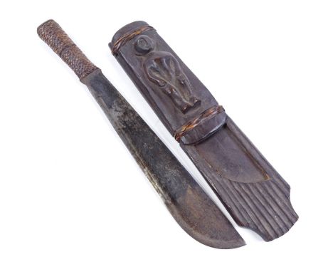 An Ethnic knife, with rattan-bound grip, original wood scabbard with relief carved figure, overall length 45cm Very good cond