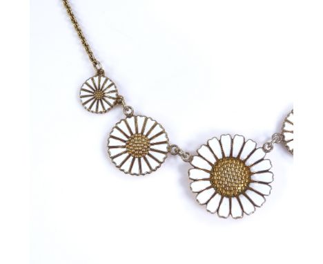 A Flemming Lund Danish vermeil sterling silver and white enamel Daisy pattern graduated necklace, largest daisy diameter 25.1