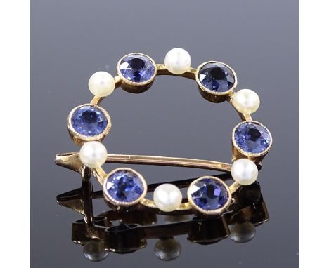 An Edwardian 15ct gold colour change spinel and pearl circular brooch, spinels changing from amethyst colour to blue, diamete
