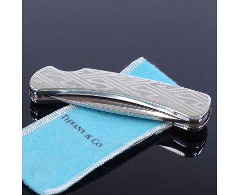 A Tiffany &amp; Co sterling silver Buck 500 folding pocket knife, engine turned geometric decoration with lock-out blade, ext