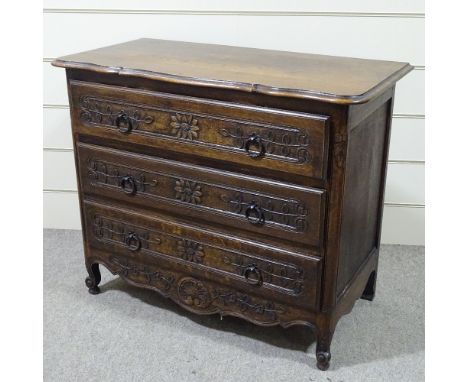 A 19th century French oak 3-drawer commode with relief carved drawer fronts, width 3'7", height 2'11" 