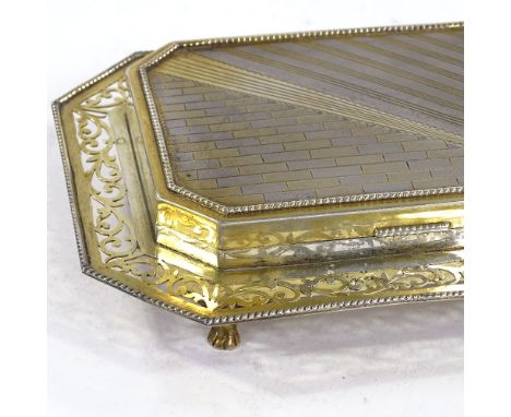 An Art Deco unmarked silver and silver-gilt desk cigarette box, engine turned brick and stripe lid with pierced foliate fretw