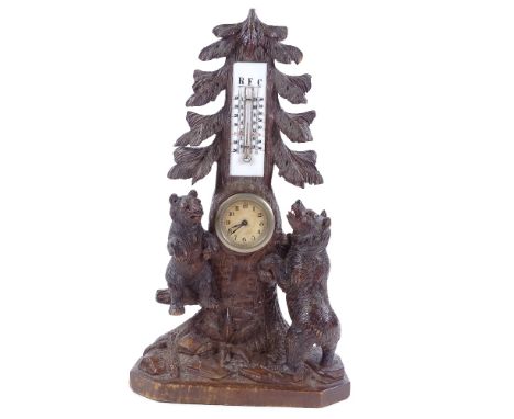 A 19th century Black Forest desk clock/thermometer, in the form of 2 bears climbing a tree, height 40cm There are a number of