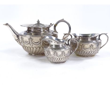 A Victorian 3-piece tea set, comprising teapot, sugar bowl and cream jug, half-fluted form with relief embossed swag decorati