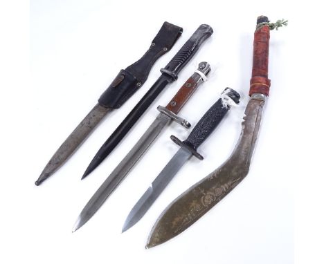 A German Second War Period bayonet and scabbard, 2 other Second War bayonets, and a kukri knife (4) 