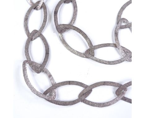 A long modernist unmarked silver necklace, openwork textured marquise panels, panel length 51.3mm, necklace length 52cm, 62.5