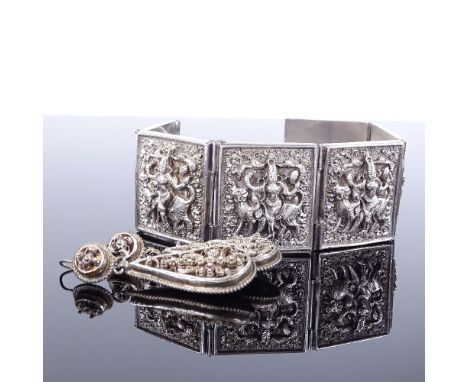 A Victorian silver panel bracelet, high relief Eastern style panels depicting Durga riding a Lion, maker's marks EU, hallmark