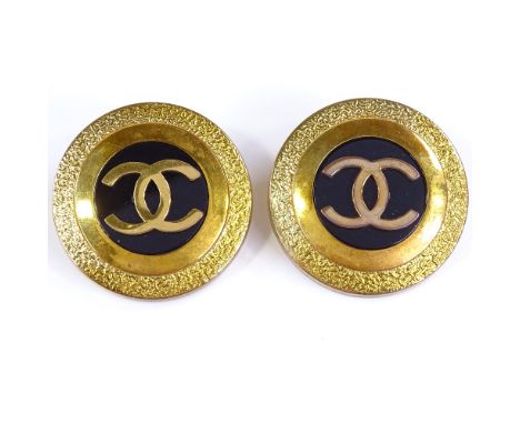 CHANEL - a pair of Vintage gold plated CC logo clip-on earrings, black resin centre panel with textured border, from 1993 Spr