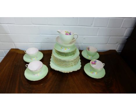 A Foley china pale green glazed and floral patterned tea set with gilt edged rims comprising twelve cups, ten saucers, twelve