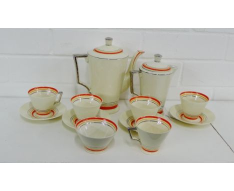 A Corona ware Art Deco coffee set comprising coffee pot, cream jug, sugar bowl, six coffee cups and five saucers with orange 