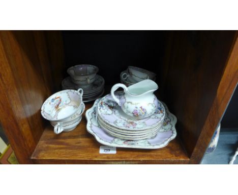 A Continental porcelain teaset comprising five cups, five saucers, five side plates, milk jug, sugar bowl and sandwich plate 