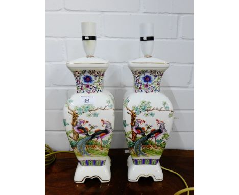 A pair of white glazed Chinoiserie ceramic table lamp bases, decorated with Peacock's, flowers and foliage, 32cm high, exclud