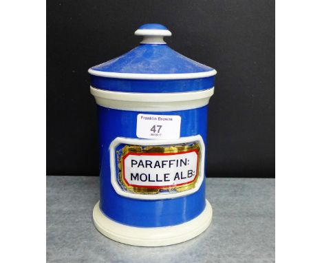 A blue glazed ceramic pharmacy jar and cover labelled 'Paraffin Molle Ale'