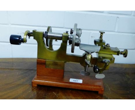 A 19th century brass and steel manual watchmakers lathe, remounted on a modern hardwood stand, 34 x 18cm 