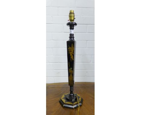 A Japanned black lacquered table lamp painted with figures and stylised motifs on an octagonal base, 53cm high excluding ligh