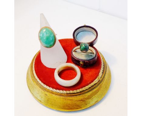 A 9 carat gold dress ring with green hardstone cabouchon together with a turquoise set dress ring and a jade ring, (3) 