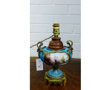 A Sevres style Celeste bleu ground baluster table lamp base with gilt metal mounts painted with figures in a garden setting w