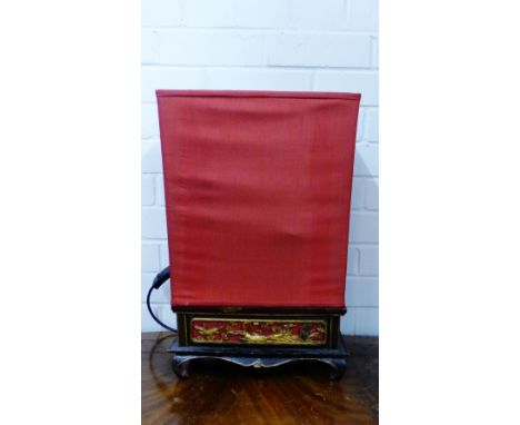A Chinoiserie table lamp with stylised wooden base on four scroll feet complete with rectangular red silk shade, 49 x 30cm 