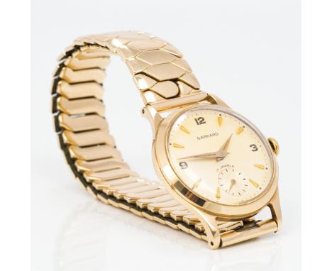 A Garrard gentleman's 9 ct gold wristwatch, hallmarked for 1965The champagne dial set with batons and Arabic numerals and wit